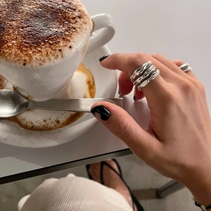 Minimalist 925 sterling silver ring with irregular wave texture on hand model