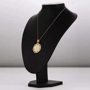 Luxurious gold flower pendant necklace with white pearl and crystals on black bust display