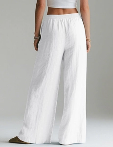 Close-up of elastic waistband and breathable linen texture on white wide-leg trousers