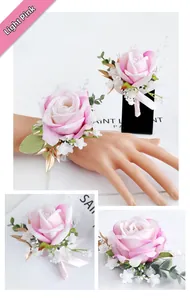 Close-up of light pink silk rose corsage and wrist flower with gold leaf details
