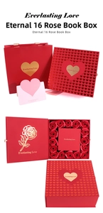 Detailed view of book-style gift box with sixteen red roses and matching heart gift bag