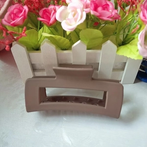 Detailed view of a 10.5cm matte light brown rectangular hair claw clip for thick hair
