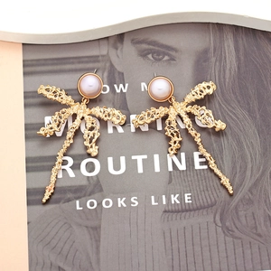 Golden statement dragonfly earrings with irregular metal texture and purple pearl
