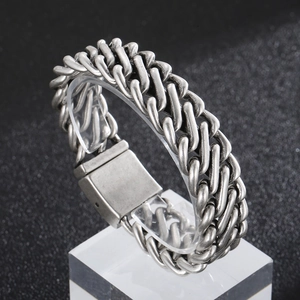 Macro shot of vintage silver Cuban chain bracelet with textured industrial link details