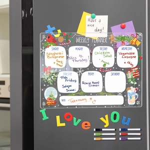 Macro view of magnetic acrylic weekly planner with Christmas theme on grey fridge