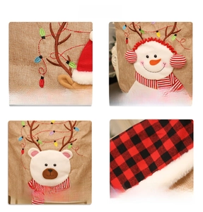 Detailed embroidery of reindeer and snowman motifs on burlap Christmas chair covers
