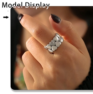 Detail view of a vintage silver-plated heart ring with sparkling crystal on a model's finger