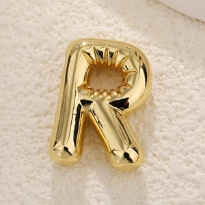 Macro view of gold plated balloon style letter R pendant with mirror polished finish