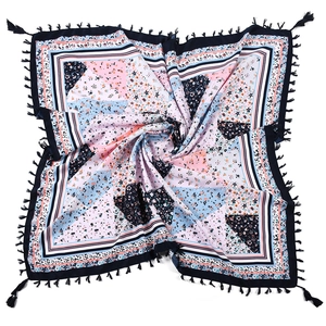 Detail of bohemian floral patchwork square scarf with black tassel fringe and patterns