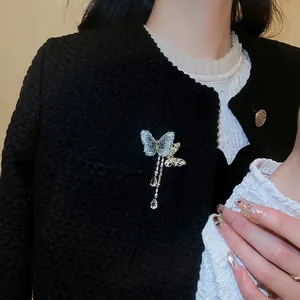 Elegant butterfly tassel brooch with blue embroidery and crystal teardrop on tweed jacket