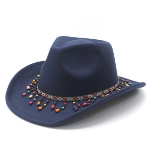 Close-up of a navy wool western cowboy hat with colorful ethnic beads and braided band