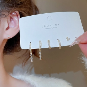 Detailed view of 6-piece gold earring set with zircon drops and sparkling rhinestones