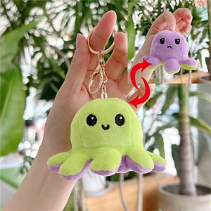 Close-up of reversible octopus plush keychain showing flip function and metal clip