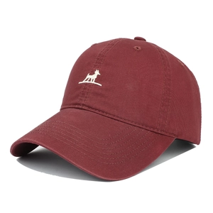 Detail of wine red cotton baseball cap with white puppy embroidery and curved brim