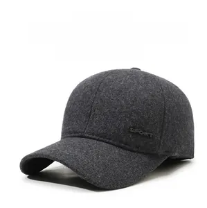 Close-up of thick grey wool baseball cap with sport metal logo and ear protection