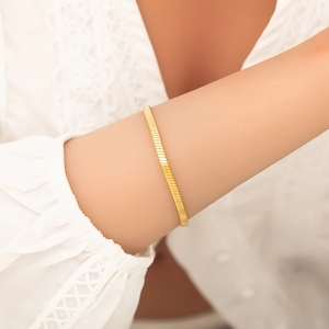 Detail of minimalist 18K gold plated stainless steel snake chain bracelet on wrist
