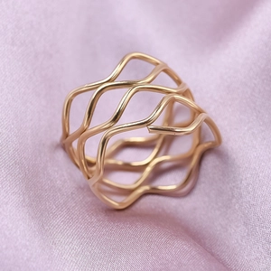 Detailed close-up of 18K gold plated 304 stainless steel wavy ring on purple silk fabric
