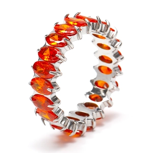 Detail of eternity ring with oval orange cubic zirconia in polished silver setting