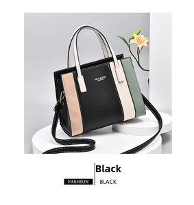 Detail view of multicolored patchwork handbag with gold metal zippers and white stitching