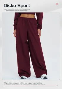 Detail view of burgundy wide-leg sports pants with drawstring waist on white background