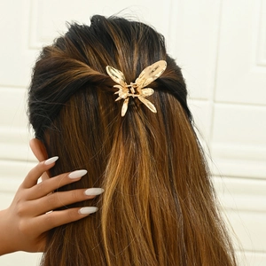 Golden liquid alloy butterfly hair claw clip shown on model for elegant hairstyle