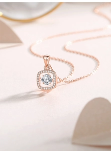 Detailed view of square halo rose gold necklace with a floating round center stone