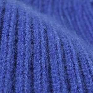 Close-up of thick rib-knitted wool bucket hat in royal blue with soft mohair texture