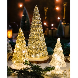 Luminous glass Christmas trees in three sizes with LED lights on a rustic wooden base