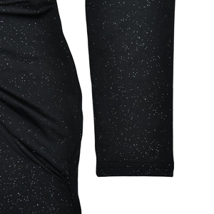 Detail of black knit dress fabric featuring silver glitter points and elegant ruching texture