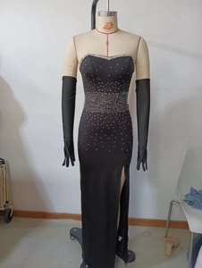 Detailed view of silver rhinestones on a black strapless slit evening dress with gloves