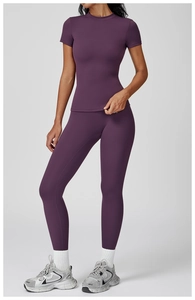 Slim fit deep purple yoga set featuring round neck short sleeve top and high waist leggings