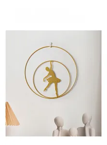 Detail of golden ballet dancer metal wall art with dual rings and cutout dress design