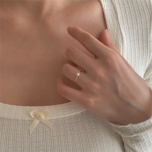 Minimalist S925 sterling silver thin ring with elegant pearl worn on female finger