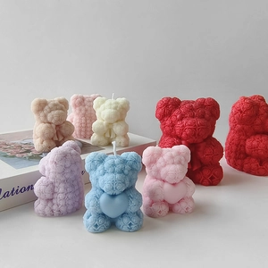 Detailed view of colorful rose teddy bear scented candles in various pastel shades