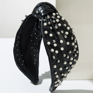 Fashionable black leather headband with white pearls and silver metal rivet studs