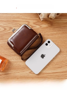 Deep brown vintage clasp purse shown alongside an iPhone to demonstrate compact size