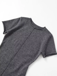 Close-up of dark grey short sleeve knit dress with ribbed texture and rolled edges
