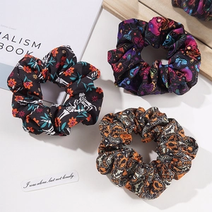 Three-piece set of Halloween scrunchies with floral, skull, and themed print patterns