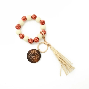 Close-up of leopard print wood beads keychain with mama engraved charm and tassel