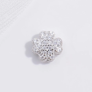 Detailed macro view of S925 sterling silver four-leaf clover earring with sparkling zircon