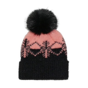 Detail of soft pink and black knit hat with snowflake pattern and faux fur pompom