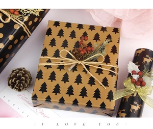 Detail of Christmas wrapping paper with gold polka dots, reindeer, and pine cone decor