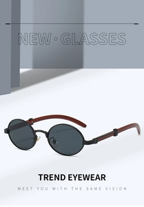 Detail of vintage oval sunglasses with wood grain temples and black metal frame
