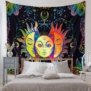 Detail of bohemian sun and moon tapestry with vibrant rainbow neon lines on black fabric