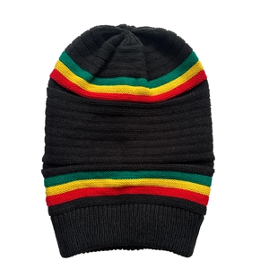 Detail view of the fine knit texture and rasta stripes on the black knit beanie