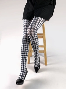 Detailed view of women's tights featuring a classic black and white houndstooth pattern