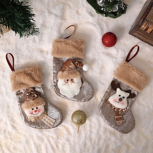 Three-piece Christmas stocking set featuring Santa, snowman, and reindeer on snowy backdrop