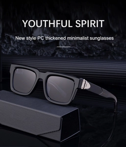 Detail view of thickened black PC square sunglasses on a textured case with high-end lighting