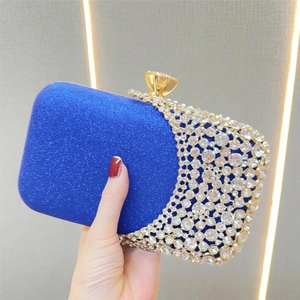 Detailed close-up of royal blue sequin evening clutch with crystal rhinestones and gold clasp