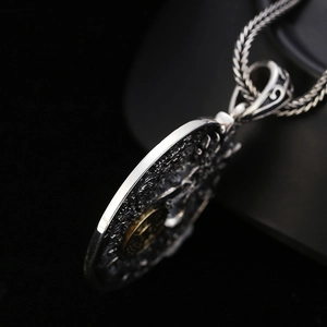 Retro sterling silver dragon pendant with rotating gold bagua wheel and braided chain